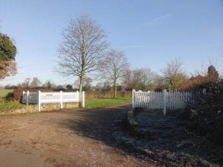 Turn right by the white fencing into Nomansland Farm.